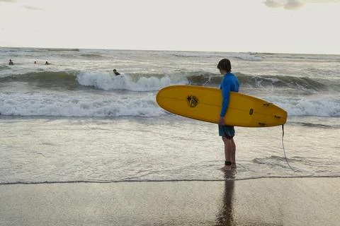 A Surfer in a Beach in Bali 写真素材