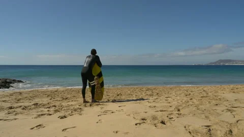 Surfer on the beach in Lanzarote Stock Footage 171136684