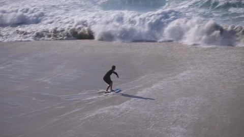 Surfer On The Beach Panning Right Stock Footage 125769160