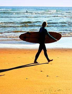Surfer on the beach Stock Photos