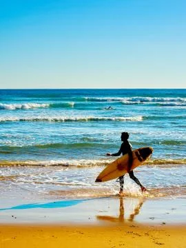 Surfer on a beach Stock Photos