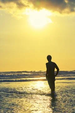 Surfer on beach Stock Photos
