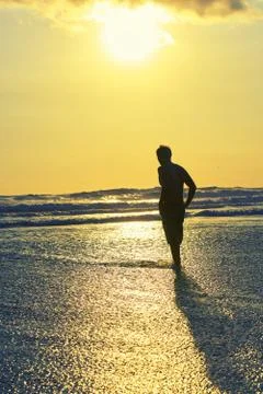 Surfer on beach Stock Photos