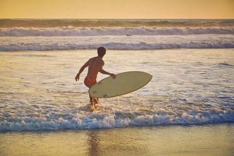 Surfer on beach Stock Photos
