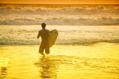 Surfer on beach Stock Photos