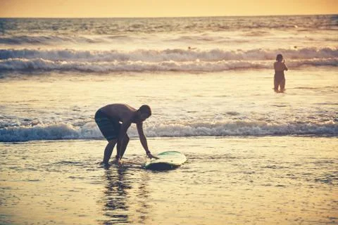 Surfer on beach Stock Photos