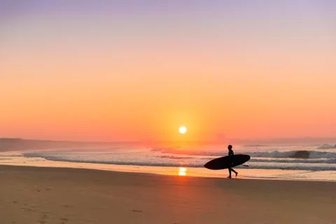 Surfer on the beach Stock Photos