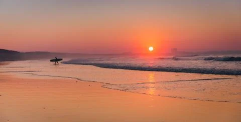 Surfer on the beach Stock Photos
