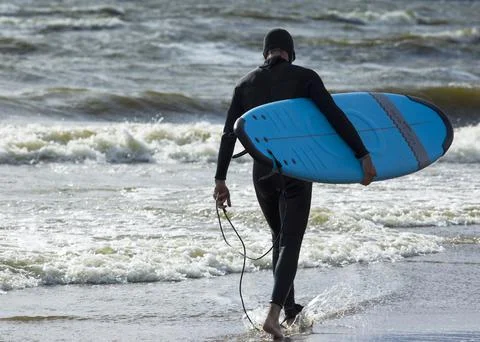 Surfer on the beach Stock Photos