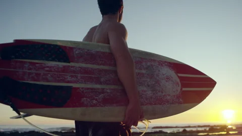 Surfer at the beach at sunset Stock Footage 279782291