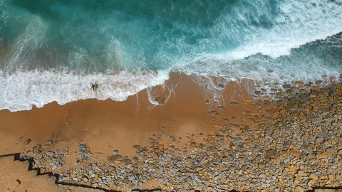 Surfer on the beach top view. Drone shot on a beach in a summer day. Stock Footage 94472474