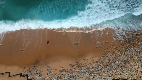 Surfer on the beach top view. Drone shot on a beach in a summer day. Stock Footage 94472490
