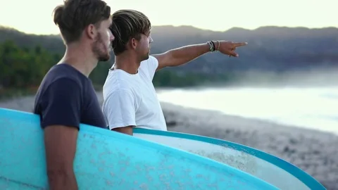 Surfer best friends on beach looking at waves to surf. summer hobby active lifes Stock Footage 108564201