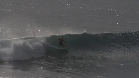 Surfer on big wave at Uluwatu Stock Footage 78521150