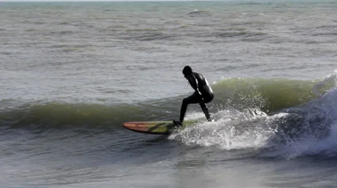 Surfer in a Black Wetsuit Surf on the Wave, Stock Footage 63574171