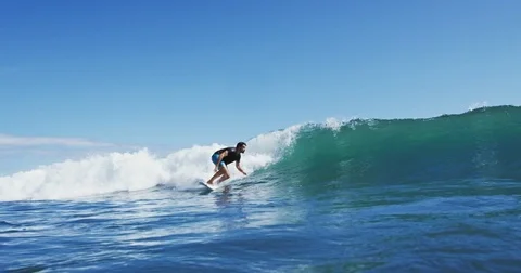 Surfer on Blue Ocean Wave Stock Footage 76283068