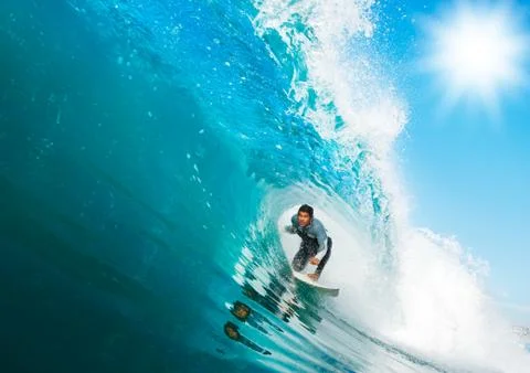 Surfer on blue ocean wave Stock Photos