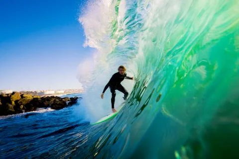 Surfer on blue ocean wave Stock Photos