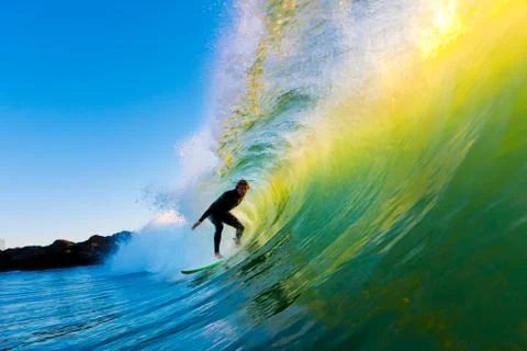 Surfer on blue ocean wave Stock Photos