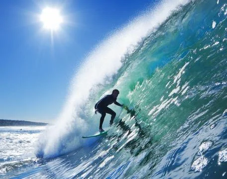 Surfer on blue ocean wave Stock Photos