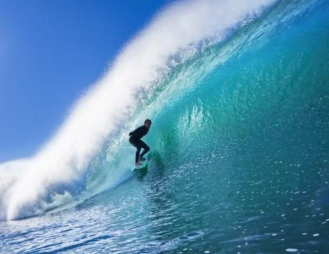 Surfer on blue ocean wave Stock Photos