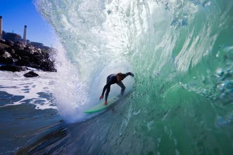 Surfer on blue ocean wave Stock Photos