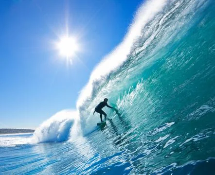 Surfer on blue ocean wave Stock-Fotos