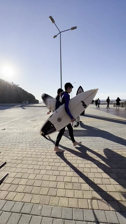 Surfer boys on Ribeira D Ilhas beach on a sunny winter day. Stock Footage 304883099