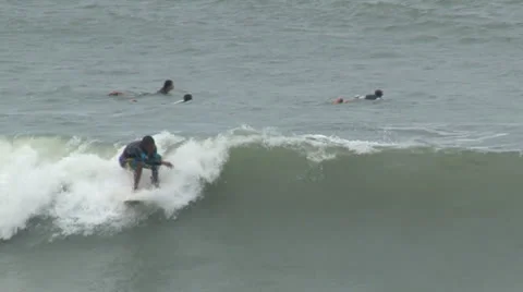 Surfer briefly catches wave. Stock-Footage 26746511