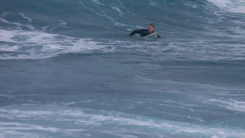 Surfer catches big wave during sunset in slow motion 4K Stock Footage 90893632