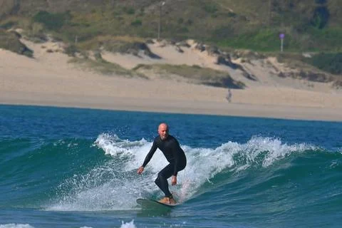 A surfer catches a dynamic wave off the coast of Ferrol (2), 18/08/2025 Stock Photos