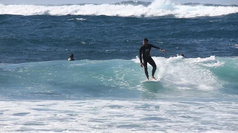 Surfer Catches Ocean Wave on longboard Stock Footage 128655407