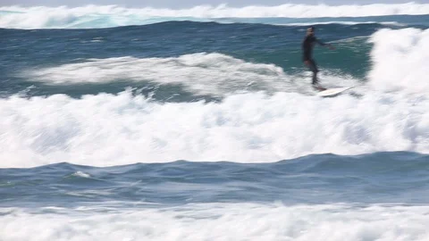 Surfer Catches Ocean Wave on longboard Stock-Footage 128655444