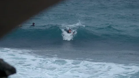 Surfer catches a wave in slow motion 4K Stock Footage 90892646
