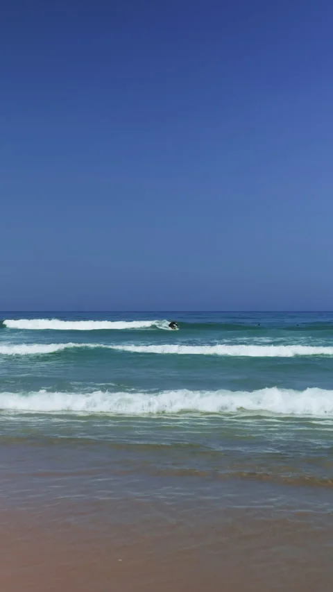 Surfer Catching and Riding Wave in Ocean Distance Stock Footage 344946364