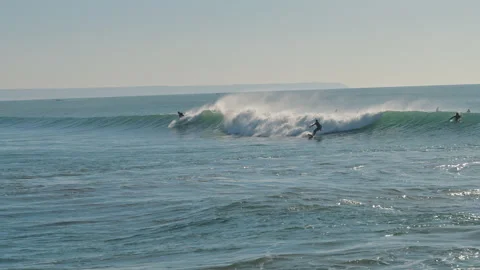Surfer catching a big wave of the Atlantic Ocean on a beautiful sunny day. Stock Footage 130626043
