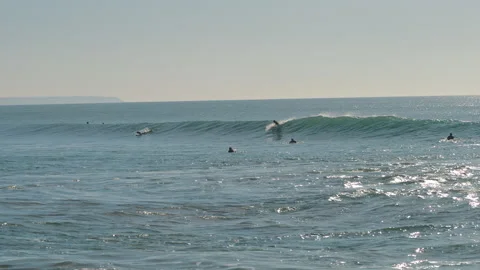 Surfer catching a big wave of the Atlantic Ocean on a beautiful sunny day. Stock Footage 130626238