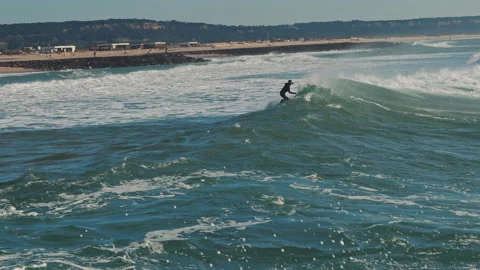 Surfer catching blue wave in the Atlantic Ocean on a beautiful sunny day. Stock Footage 130627852