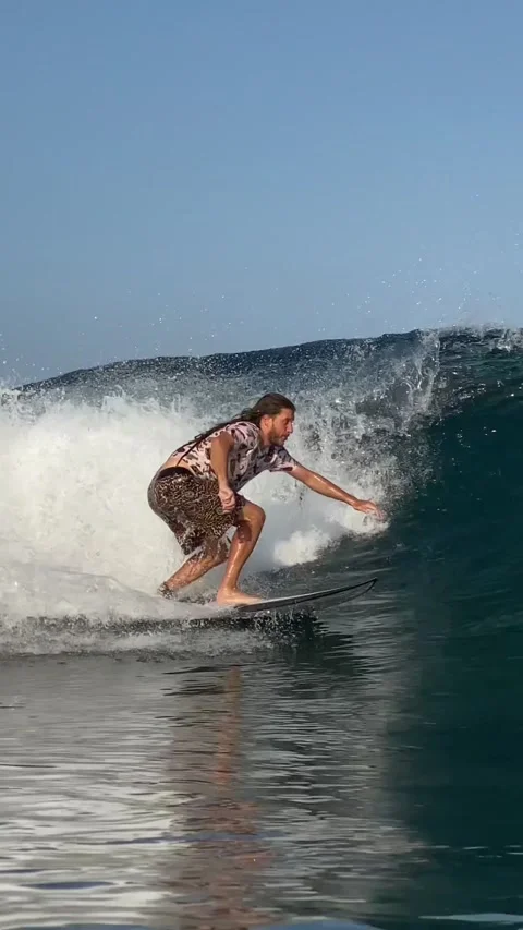 Surfer catching a blue wave.Vertical video Stock Footage 300750249