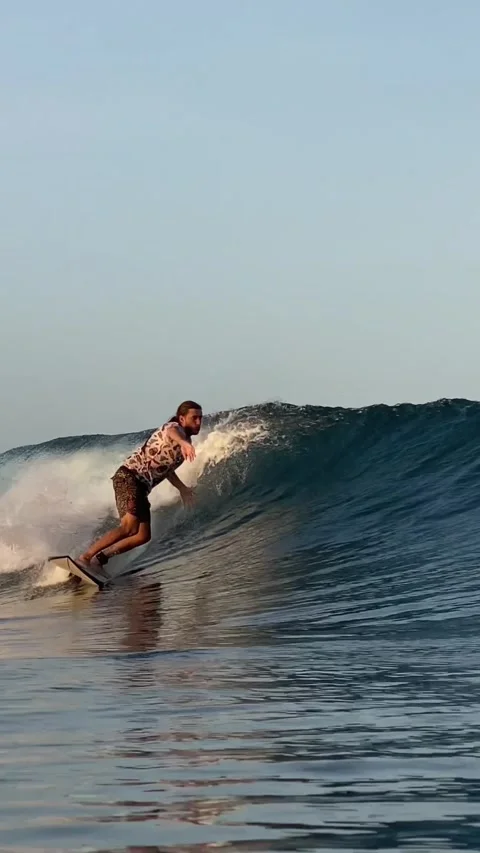 Surfer catching a blue wave.Vertical video Stock Footage 300750261