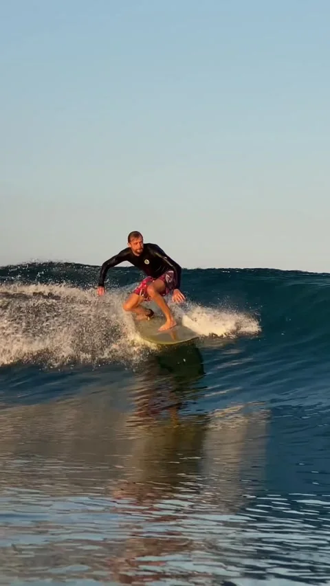 Surfer catching a blue wave.Vertical video Stock Footage 300750264