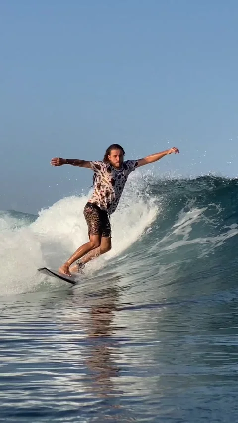 Surfer catching a blue wave.Vertical video Stock Footage 300750278