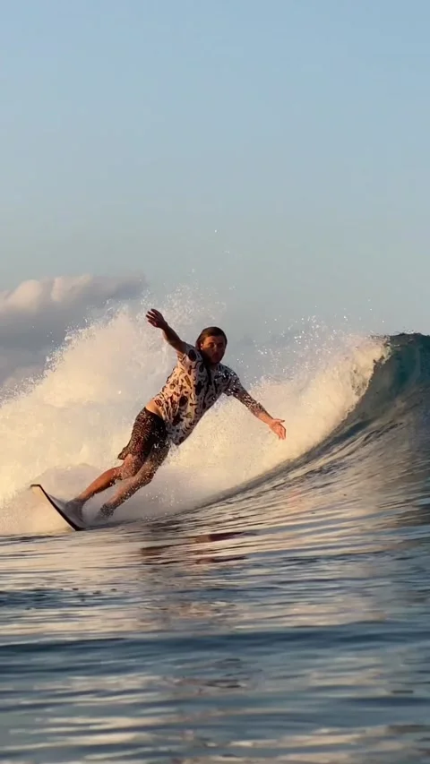 Surfer catching a blue wave.Vertical video Stock Footage 300750291