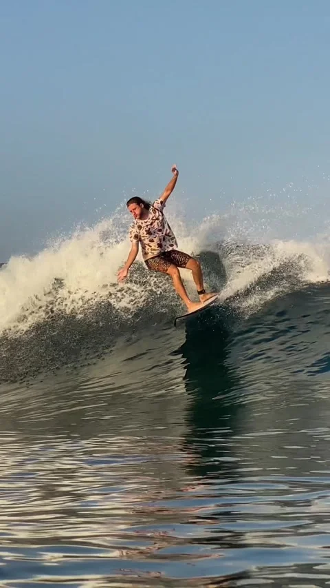 Surfer catching a blue wave.Vertical video Stock Footage 300750292