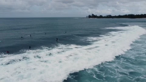 Surfer catching a long wave in the sea on a cloudy day. Stock Footage 284834033