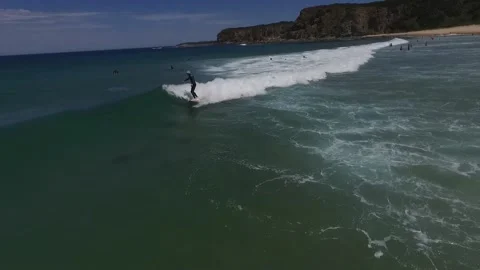 Surfer catching a small waves at The Oaks beach, VIC, Australia. Stock Footage 146578058