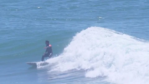 Surfer catching wave in beach slow motion Stock Footage