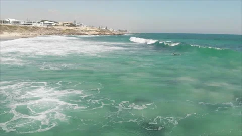 Surfer catching a wave slow-motion aerial tracking shot Stock Footage 182335703