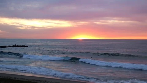 Surfer catching wave at sunset Stock Footage 82849890