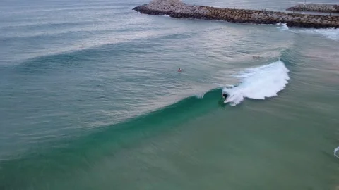 Surfer Catching Wave at Sunset Stock Footage 331605854